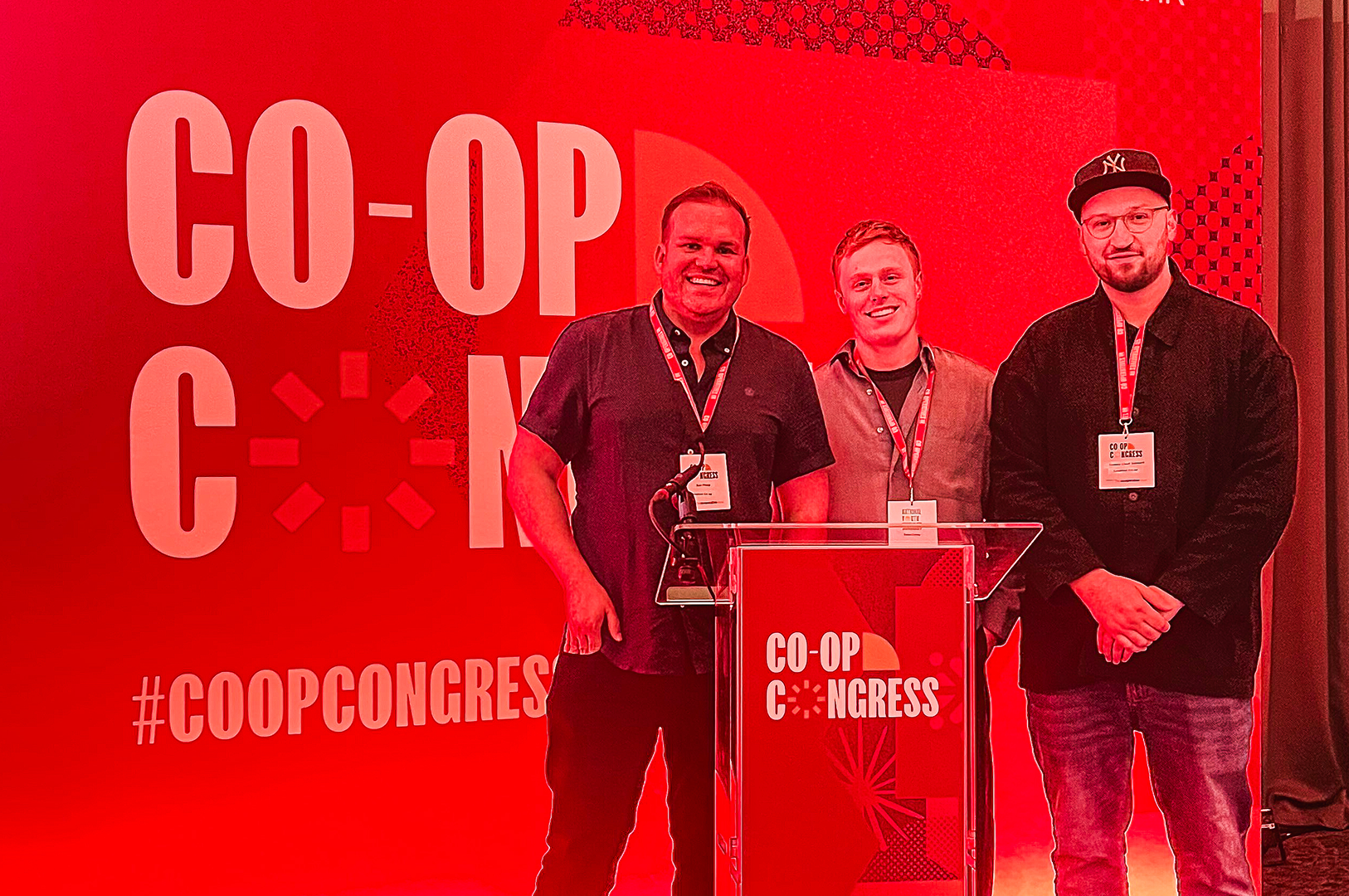 Three speakers on stage at Co-op Congress